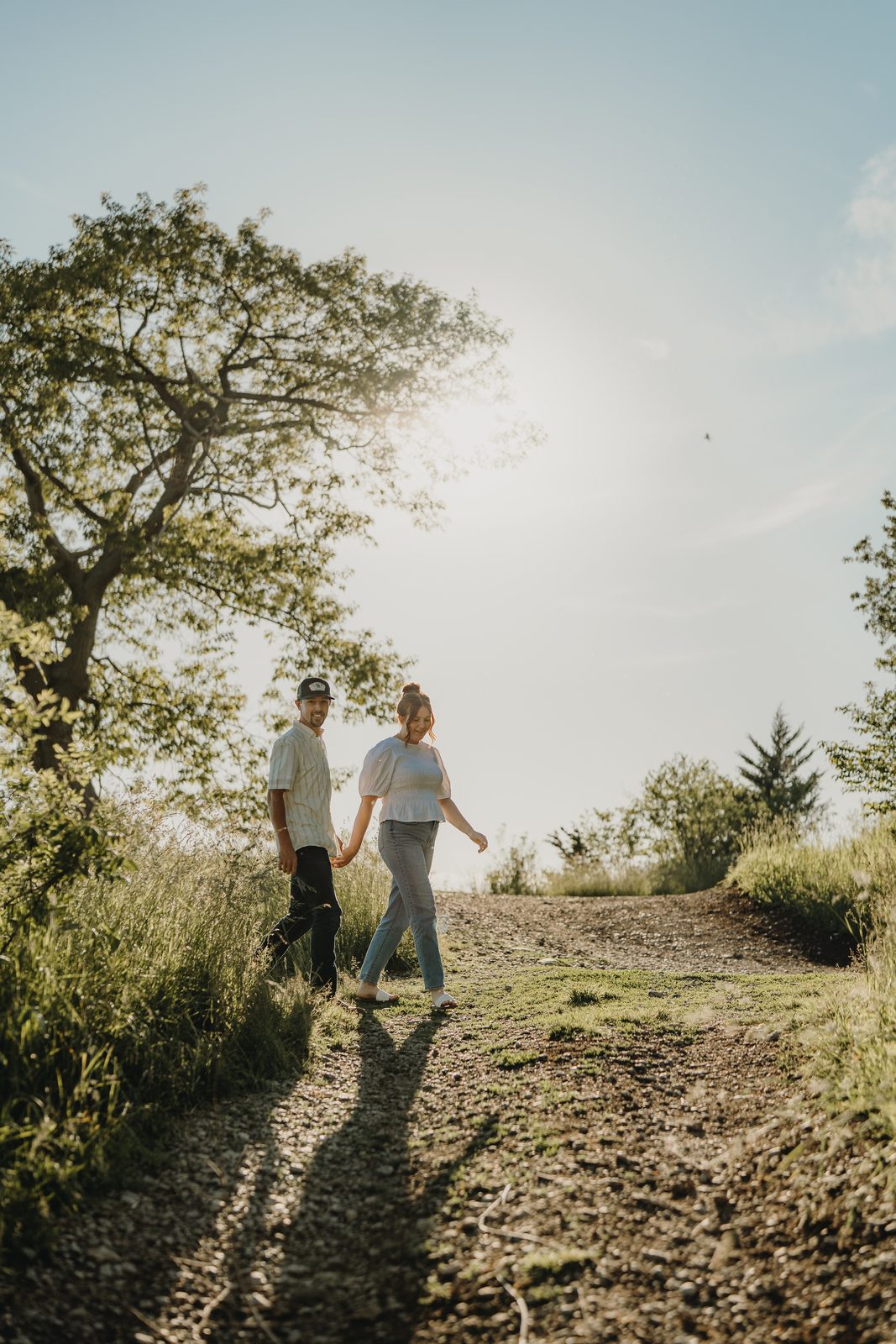 Natural, candid engagement photo at golden hour in Prince Edward County