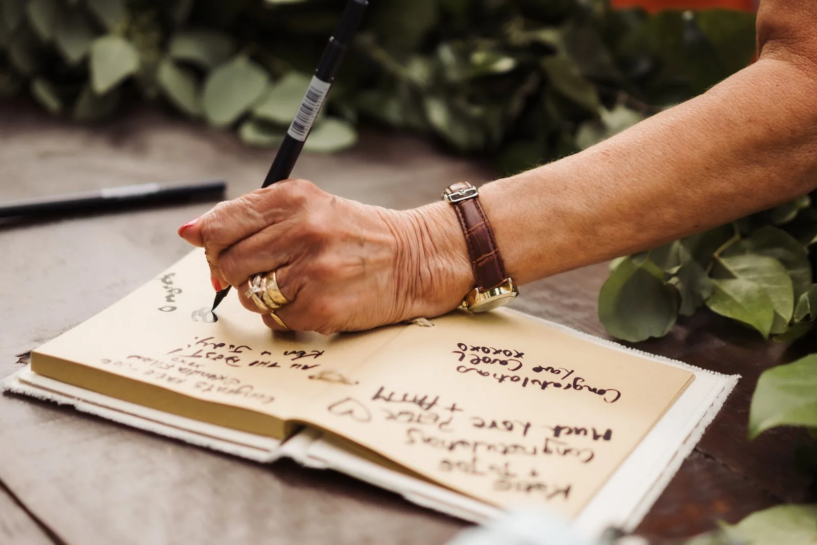 Guest signing the guest book at a backyard wedding near Kitchener, Ontario