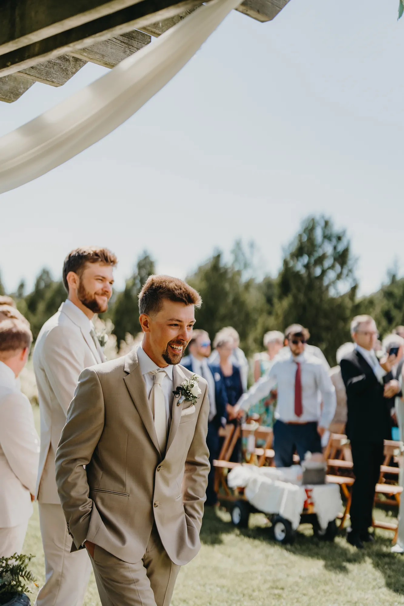 Groom smiling as he sees the bride for the first time during the ceremony