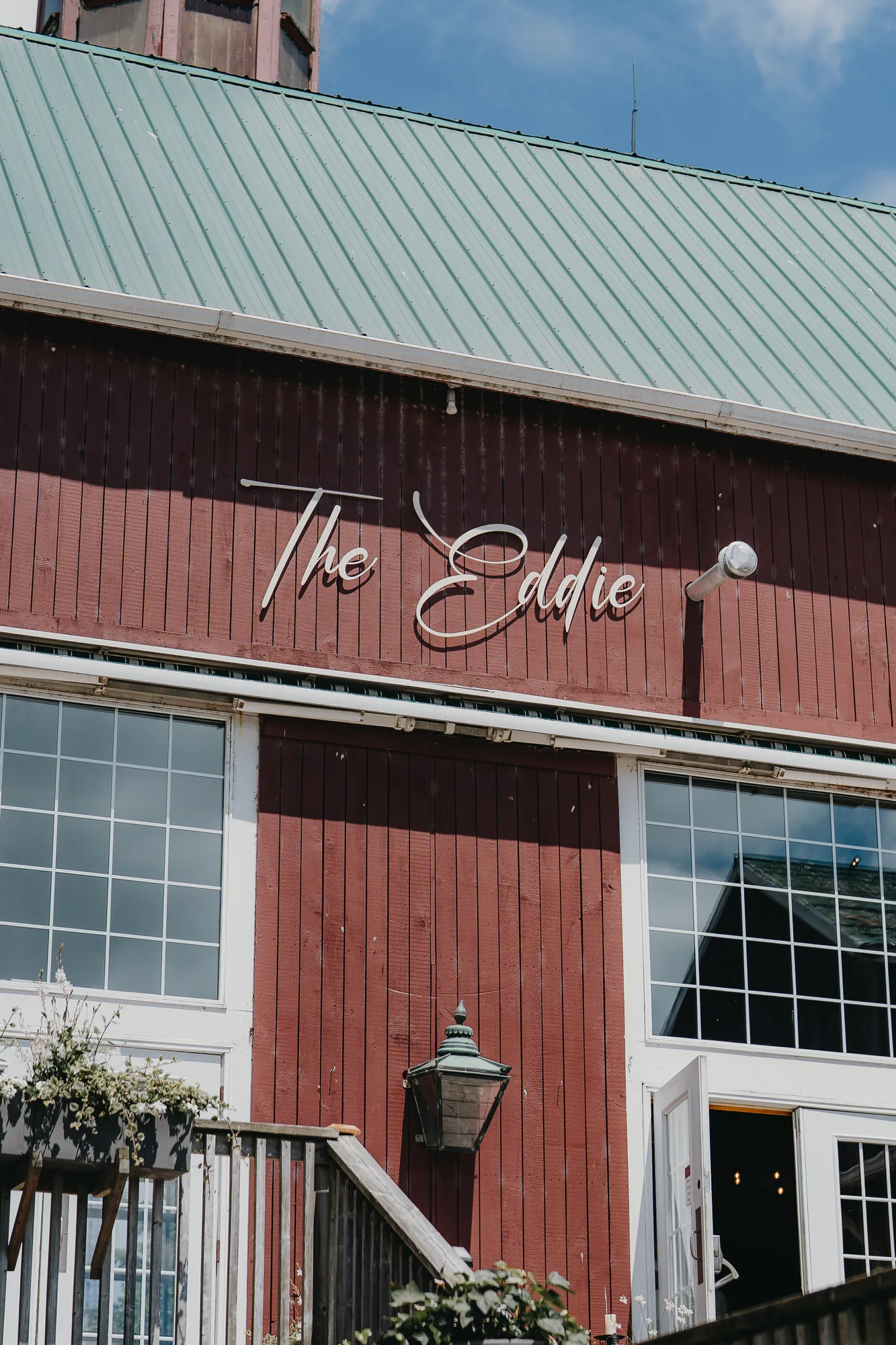 The Eddie Hotel & Farm red barn sign under a green metal roof, Prince Edward County wedding venue