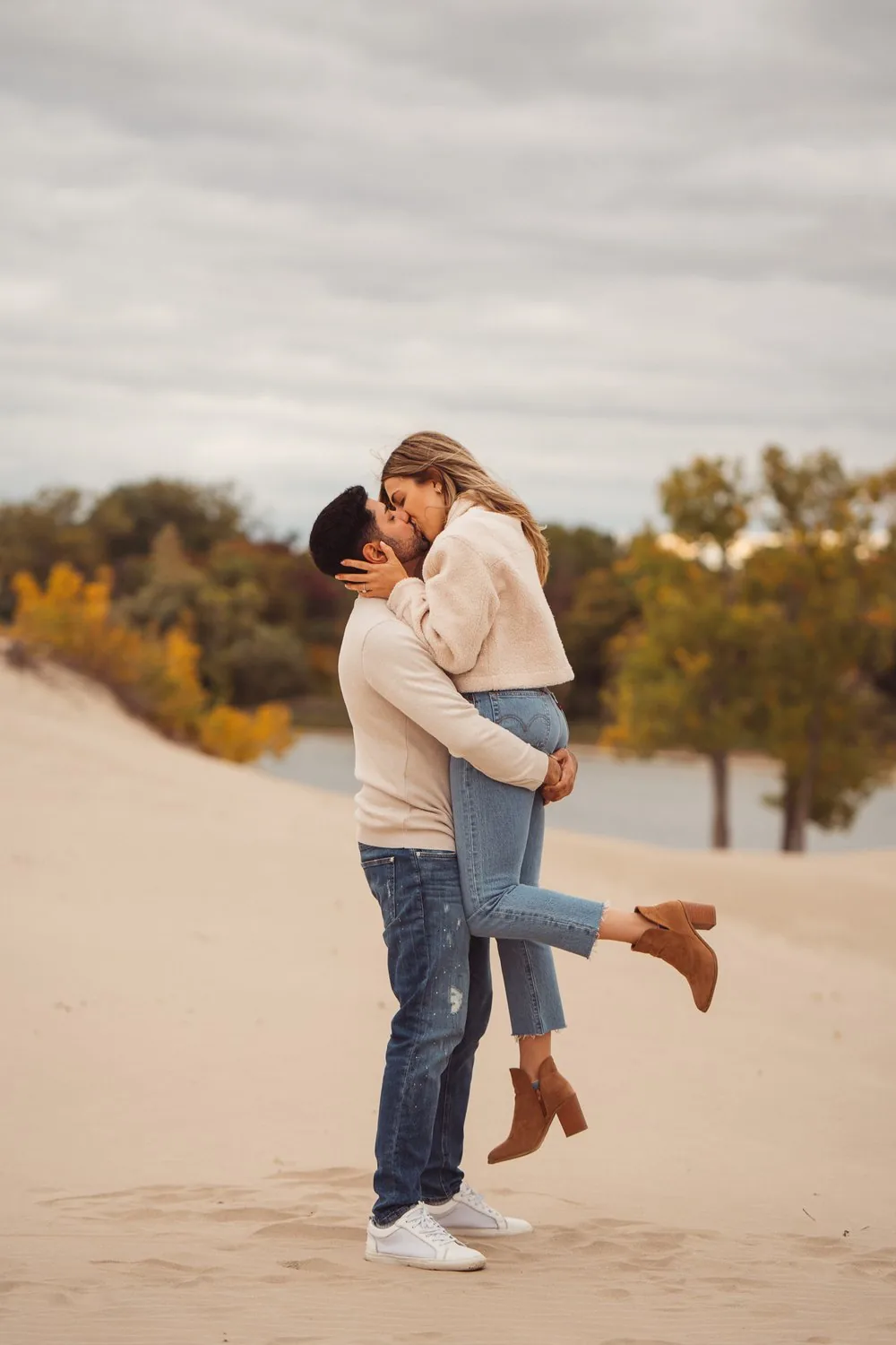 Couple holding each other in an autumn field at dusk